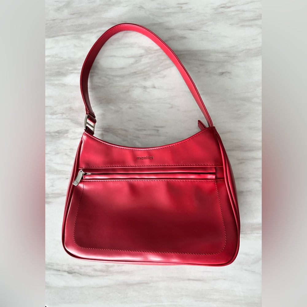 Mantles purse, deep red in colour with soft finishes.